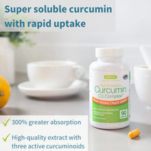 Bottle of Curcumin C3 Complex with text about super soluble curcumin and rapid uptake on a table with a cup and orange.
